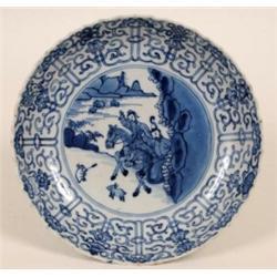 An 18th Century Chinese Blue and White Dish, decorated figures on horseback. within a floral bord...