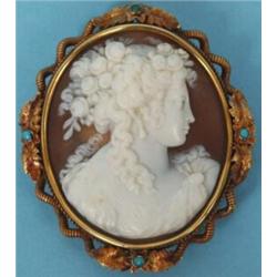 A Victorian Oval Cameo Brooch, carved a bust of a lady with flowers in her hair, in a yellow meta...