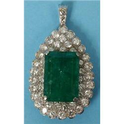 An 18 ct White Gold Tear Drop Pendant, set a large emerald within 45 diamonds  See illustration...