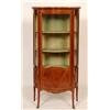 Image 1 : A French Vitrine, of serpentine form, the marble top above a glazed and paneled door, with kingwo...