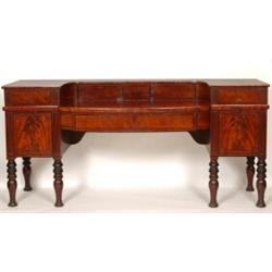 An Early 19th Century Scottish Mahogany Sideboard, having a bow front central section flanked by...
