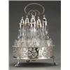 Image 1 : SILVER - A George III small circular five-bottle cruet frame, on three claw-and-ball feet, the s...