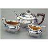Image 1 : SILVER - An Edwardian three-piece boat shaped tea service, in George III style, half spirally lo...