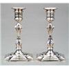 Image 1 : SILVER - A pair of George II style boudoir candlesticks, with re-entrant square bases and confor...