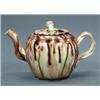 Image 1 : BRITISH POTTERY - A creamware small teapot and cover, with tortoiseshell glaze, beaded border, t...