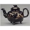 Image 1 : BRITISH POTTERY - A Jackfield black glaze globular teapot and cover, with branch handle and spou...