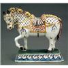 Image 1 : CONTINENTAL CERAMICS - A faience model of a caparisoned horse, on oblong base, painted in blue,...