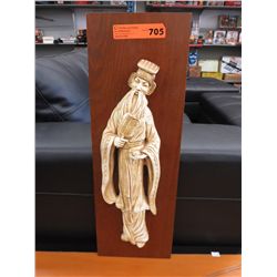 3D plaster figure on a wall plaque