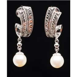 One pair of pearl drop earrings  in a white gold  leaf design.  Est.:  $150 - $200