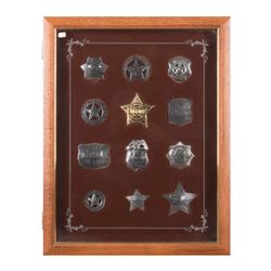 Framed display containing 12 high quality  reproduction badges in sterling silver copied from  famou