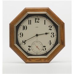 Modern octagon Howard Miller oak wall clock  approx. 20” in diameter, battery operated.     Est.:  $