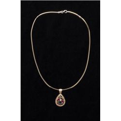 One beautifully designed pendant in 14 k yellow  gold set with rubies, sapphires, emerald and  diamo