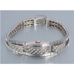 One ladies diamond bracelet cum watch in 14k white  gold and diamonds (gold wt 30gms).  Est.:  $1250