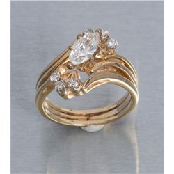 One 14k yellow gold ladies ring set with a marquee  diamond weighing approx. 0.75ct and 6 side  diam