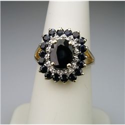 Elegant Blue Sapphire and Diamond Ring with  approx. 2.00 carat oval Sapphire encircled with 14  rou