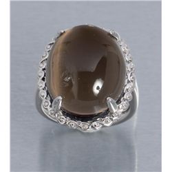 One white gold ring set with a large Smokey topaz  cabochon weighing approx.    30.00 cts.  Est.:
