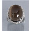 Image 1 : One white gold ring set with a large Smokey topaz  cabochon weighing approx.    30.00 cts.  Est.: