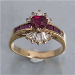One fine heart shaped ruby set in ballerina style  ring with tapered baguettes and square rubies.  E