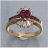 Image 1 : One fine heart shaped ruby set in ballerina style  ring with tapered baguettes and square rubies.  E