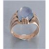 Image 1 : One mans ring in 18k yellow gold set with a  approx. 8 ct light blue sapphire cabochon with a  hint