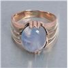 Image 3 : One mans ring in 18k yellow gold set with a  approx. 8 ct light blue sapphire cabochon with a  hint
