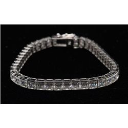 One 14k white gold tennis bracelet set with fine  princess cut cubic zirconium  (gold value  $175).