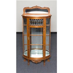 Carved oak with leaded and beveled glass curio  cabinet including bowed front; approx. 65” tall by