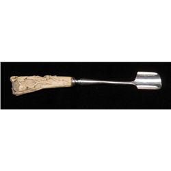 Stilton scoop with silver plated metal and fancy  oriental carved bone grip in fruit blossoms. Est.: