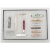 Image 2 : Riker case of 12 misc. pocket knives including  several advertisers such as a Winchester-Western,  a
