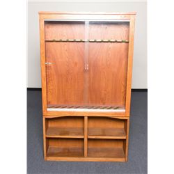 Oak gun cabinet, approx. 54” in height, 48-1/2”  wide, 12”deep with two sliding glass doors; built