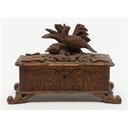 Small black forest style antique carved wooden box  with game birds; old damage to front lid edge.