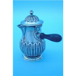 A George II Irish silver pear-shaped hot milk jug with domed cover and turned rosewood handle to...