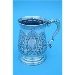 A George II silver baluster mug with scroll handle on circular spreading base, with later floral...