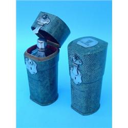 A near pair of early 19th century faceted cut glass flasks with screw on silver lids contained in...
