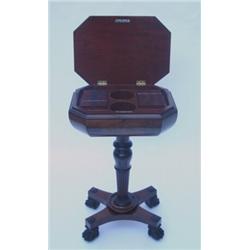 A William IV mahogany teapoy of sarcophagus form having moulded canted top enclosing fitted inter...