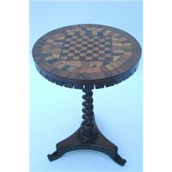 A Victorian rosewood and parquetry games table, the circular top inlaid for chess and with specim...