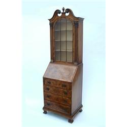 A Queen Anne style burr walnut bureau bookcase having broken swan-neck pediment over shaped glaze...
