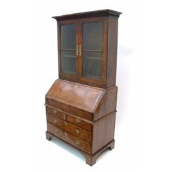 A George II walnut bureau bookcase, feather-banded and crossbanded having modified moulded and de...