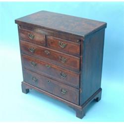 A George I feather-banded walnut bachelor's chest with quarter-veneered flap and having 2 short a...
