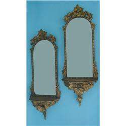 A pair of 19th century gilt wall mirrors, each having arched bevelled plate, in foliate frame ove...