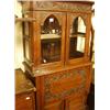 Image 1 : Carved oak drinks cabinet with shaped glazed doors…