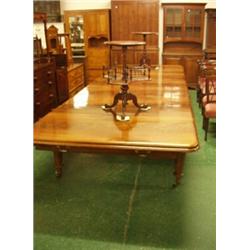 Six legged flame mahogany dining table with five original leaves, ring turned legs, brass castors…