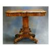 Image 1 : A William IV rosewood card table of serpentine outline raised on a carved chamfered column ending...