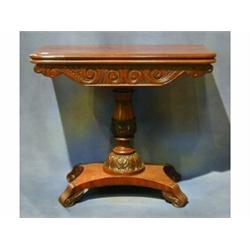 A William IV mahogany tea table with crossbanded top and carved apron, raised on a turned and car...