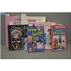 Selection of soft and hard cover doll reference guides including Barbie, Canadian dolls, blue books 