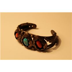 ONE SILVER NAVAJO AMERICAN INDIAN CUFF STYLE TURQUOISE AND CORAL BRACELET. SIGNED BY NAVAJO ARTIST