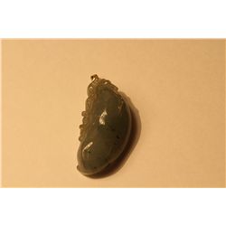 ONE OVAL SHAPED CARVED NATURAL BURMESE JADITE PENDANT CARVED IN A DESIGN OF DOMED AND ELONGATED