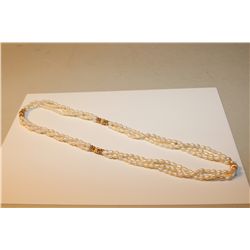 ONE LONG ROPE OF THREE STRANDS OF OVAL SHAPED WHITE FRESH WATER CULTURED PEARLS ACCENTED BY A