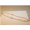 Image 1 : ONE LONG ROPE OF THREE STRANDS OF OVAL SHAPED WHITE FRESH WATER CULTURED PEARLS ACCENTED BY A