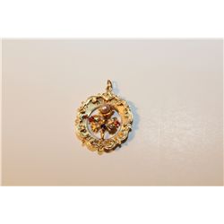 ONE 14KT. YELLOW GOLD ROUND SHAPED ORCHID AND SCROLL DESIGN PENDANT,  SET WITH 1 ROUND WHITE